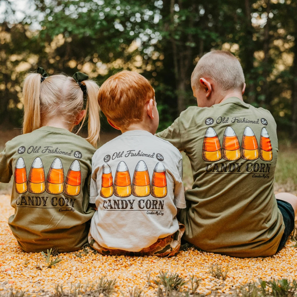 Three children wearing Cardin McCoy candy corn tees.