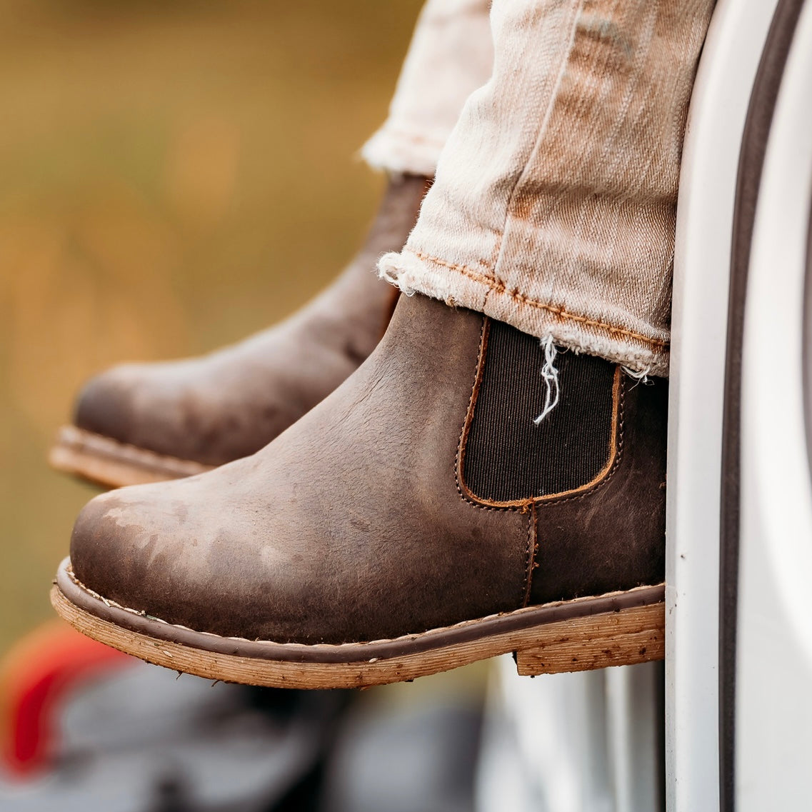 Close-up of a chocolate Chelsea boot with an elastic side panel.
