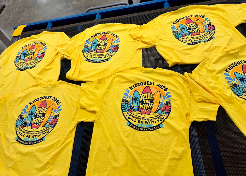 A batch of yellow KidzQuest T-shirts printed for a church youth group.